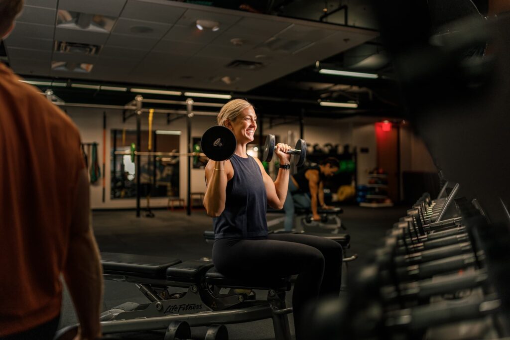 Woman does free weights in fitness center