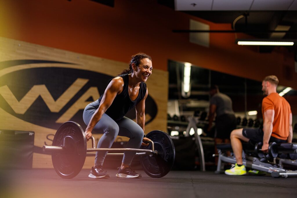Woman weight lifting in fitness center