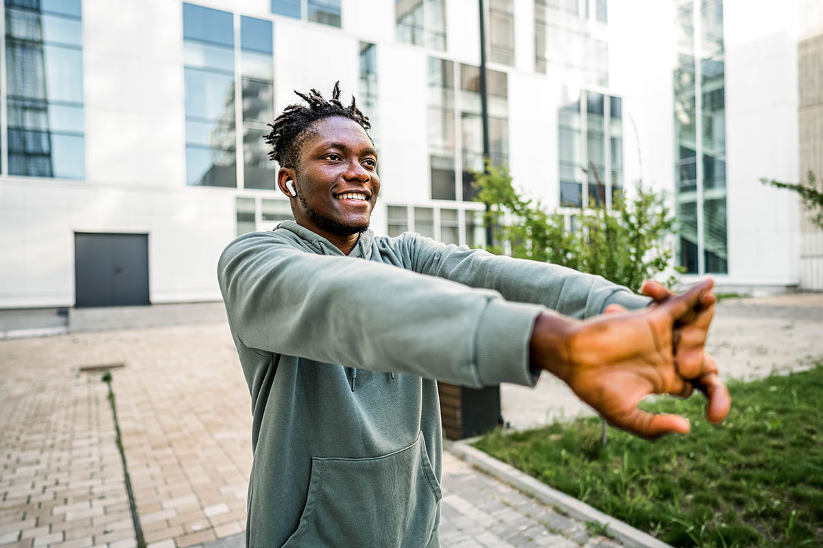 Man stretches outside of an office building