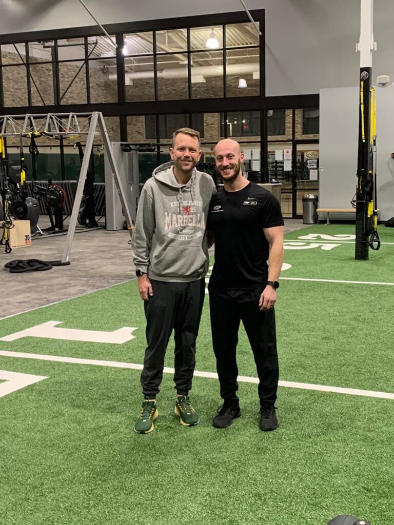 Trainer poses with his client