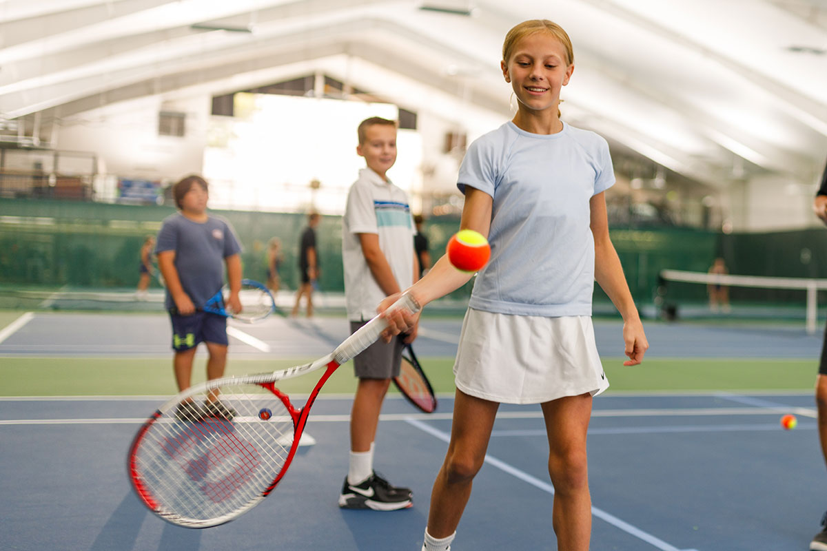 Young girl learns to play tennis at the WAC Junior Tennis Lessons
