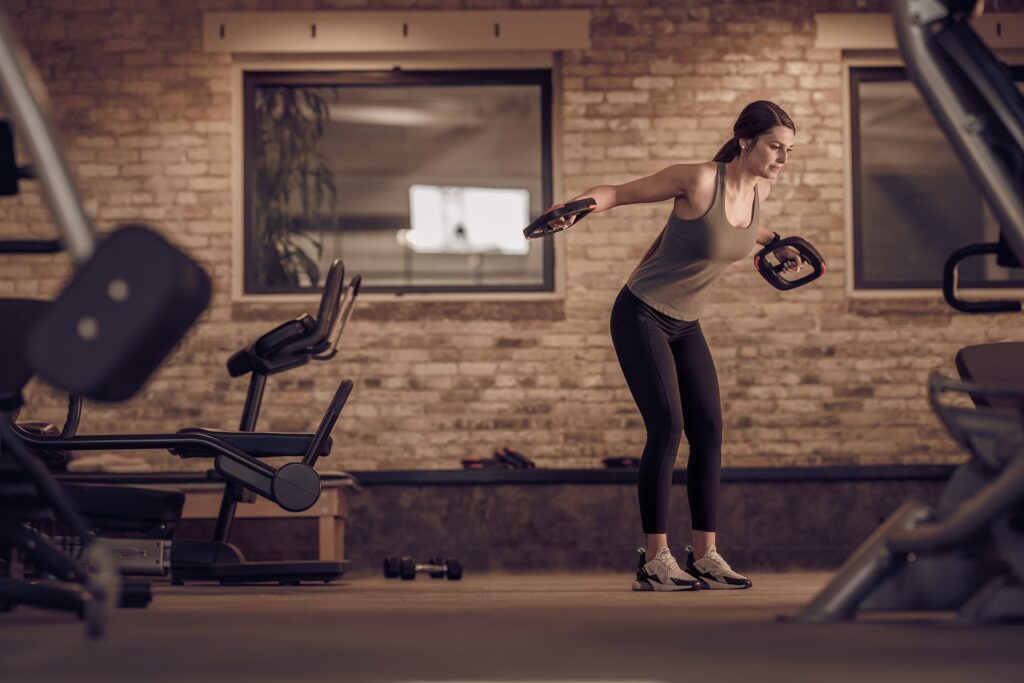 Woman does solo workout in fitness center