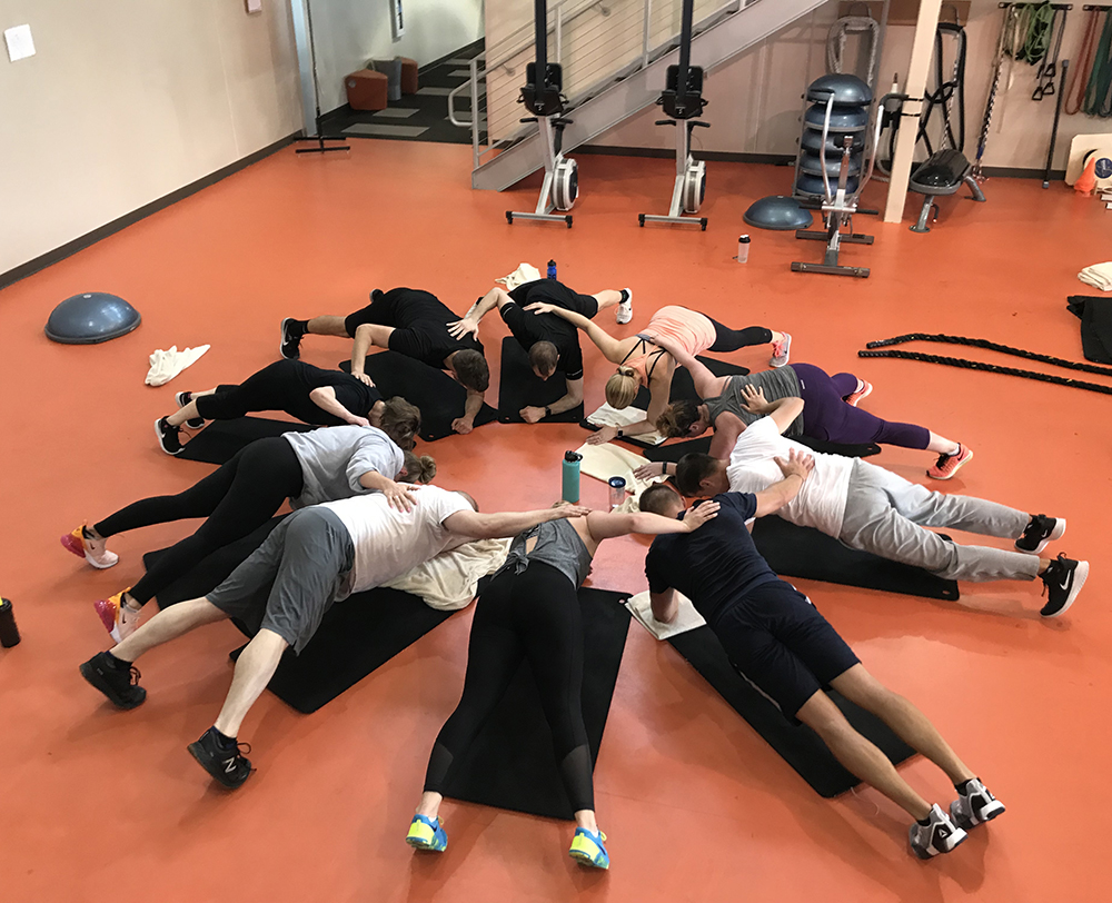 Fitness center staff do team workout