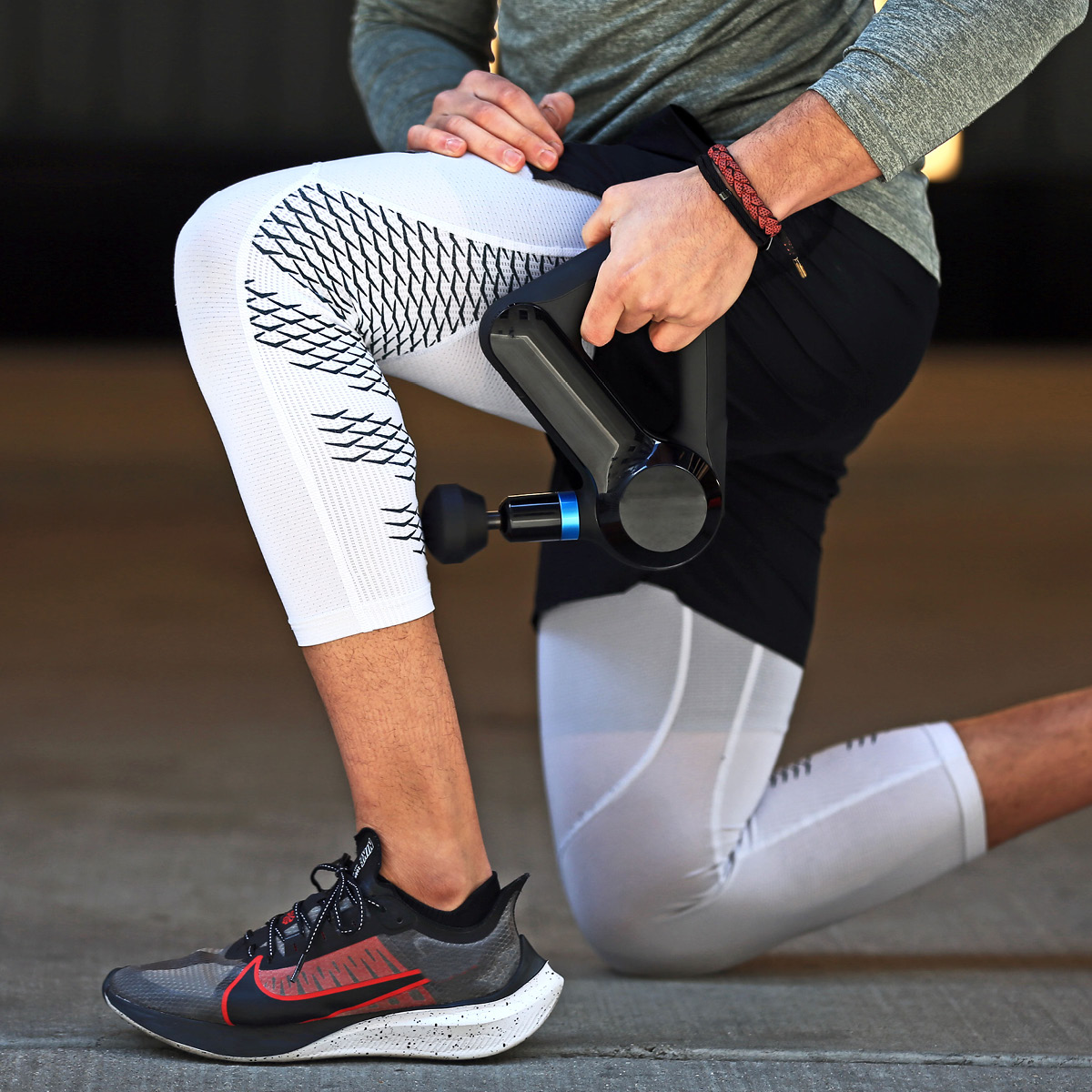 Man uses massage gun on calf