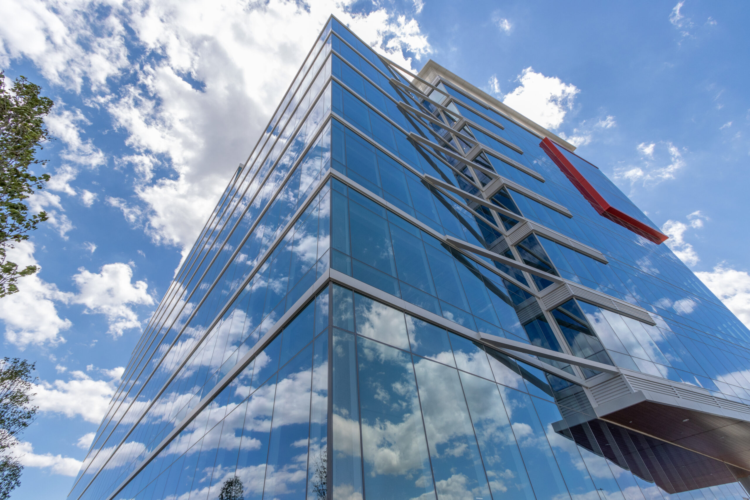 Photo looking up on an urban glass apartment building