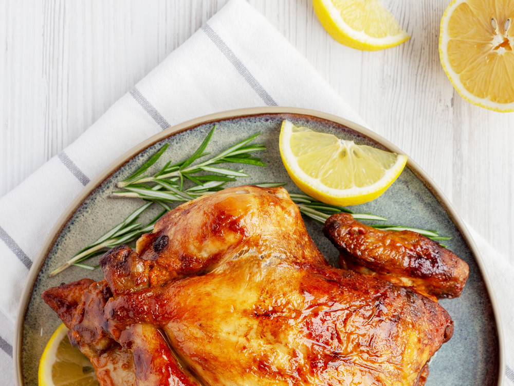Roasted chicken on a plate with lemon